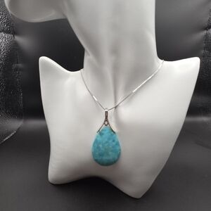 Teardrop-shaped turquoise pendant with 18in Chain. 2 Inch Extender.